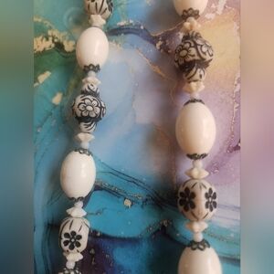40 Inch Necklace With Black And White Beads Of Differing Sizes With Floral Motif